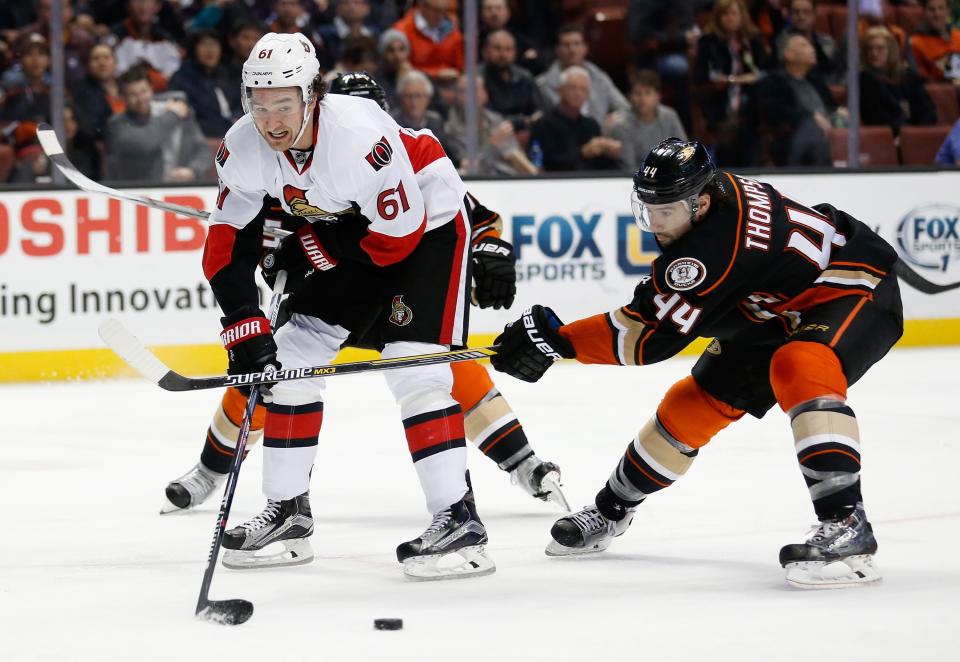 ANAHEIM, CA - JANUARY 13:  Mark Stone #61 of the Ottawa Senators battles Nate Thompson #44 of the Anaheim Ducks for a loose puck during the second period of a game at Honda Center on January 13, 2016 in Anaheim, California.  (Photo by Sean M. Haffey/Getty Images)