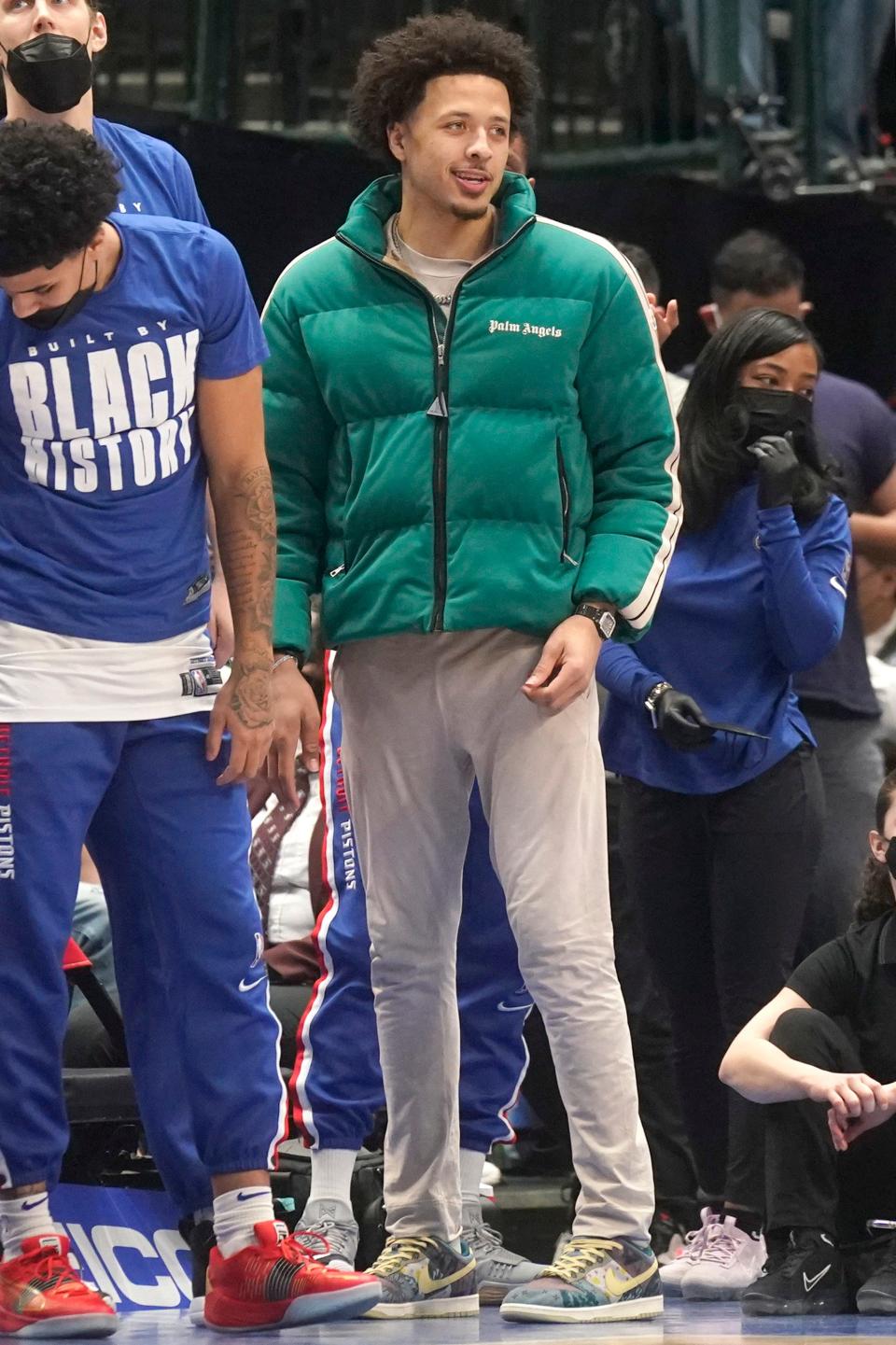 Detroit Pistons' Cade Cunningham, dressed in street clothes, watches from the sidelines during the first quarter of an NBA basketball game against the Dallas Mavericks in Dallas, Tuesday, Feb. 8, 2022.