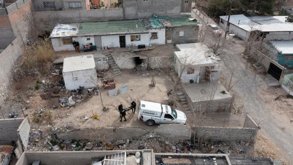 The remains of two unidentified persons are removed by Mexican coroner officials from a home on Feb. 15 after officials were tipped about a "narco grave" at this home Juárez.