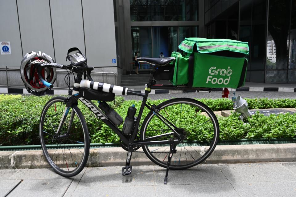 A Grab food delivery bicycle is parked along pavement at Raffles Place in Singapore on September 15, 2020. (Photo by Roslan RAHMAN / AFP) (Photo by ROSLAN RAHMAN/AFP via Getty Images)