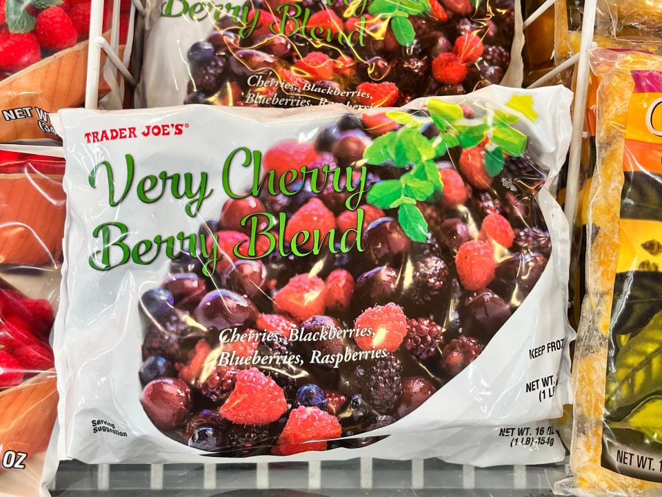 Bags of Trader Joe's very cherry berry blend, which includes cherries, blackberries, blueberries, and raspberries, in a freezer at Trader Joe's.