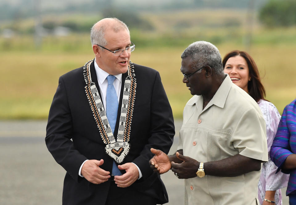 Australian Prime Minister Scott Morrison (left) is seen with Solomon Islands Prime Minister Manasseh Sogavare (right) after arriving at Honiara International Airport, in the Solomon Islands in 2019