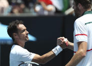 Italy's Fabio Fognini, left, is congratulated by Reilly Opelka of the U.S. after winning their first round singles match at the Australian Open tennis championship in Melbourne, Australia, Tuesday, Jan. 21, 2020. (AP Photo/Dita Alangkara)