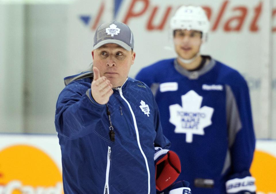 Toronto Maple Leafs interim co-head coach Steve Spott, right, explains a drill during a practice at the team&#39;s practice facility in Toronto following the firing of head coach Randy Carlyle on Tuesday, Jan. 6, 2015. (AP Photo/The Canadian Press, Darren Calabrese)