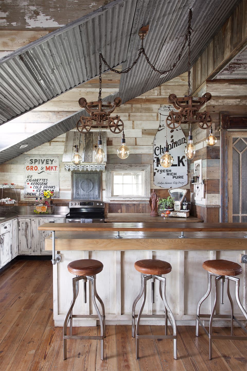 a farmhouse kitchen using reclaimed wood and lighting and signage to decorate