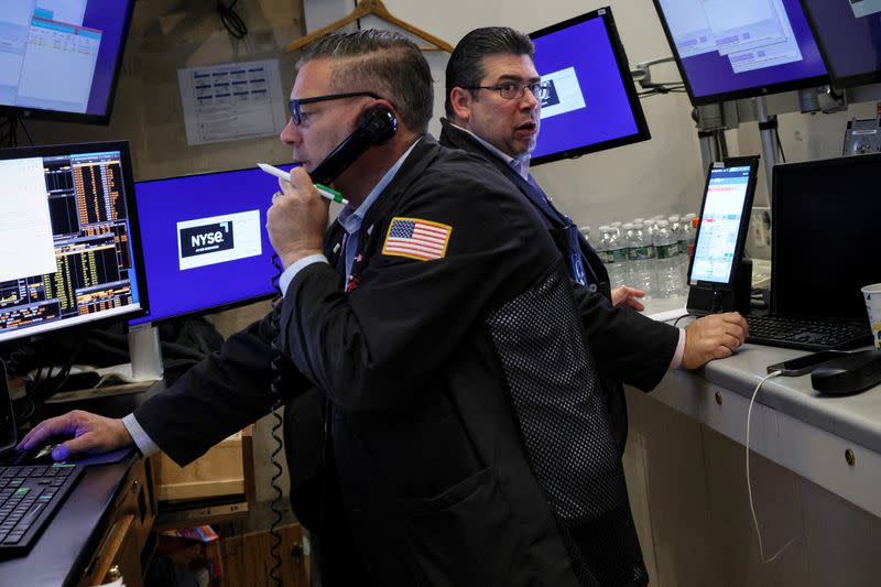 Traders work on the floor of the NYSE in New York