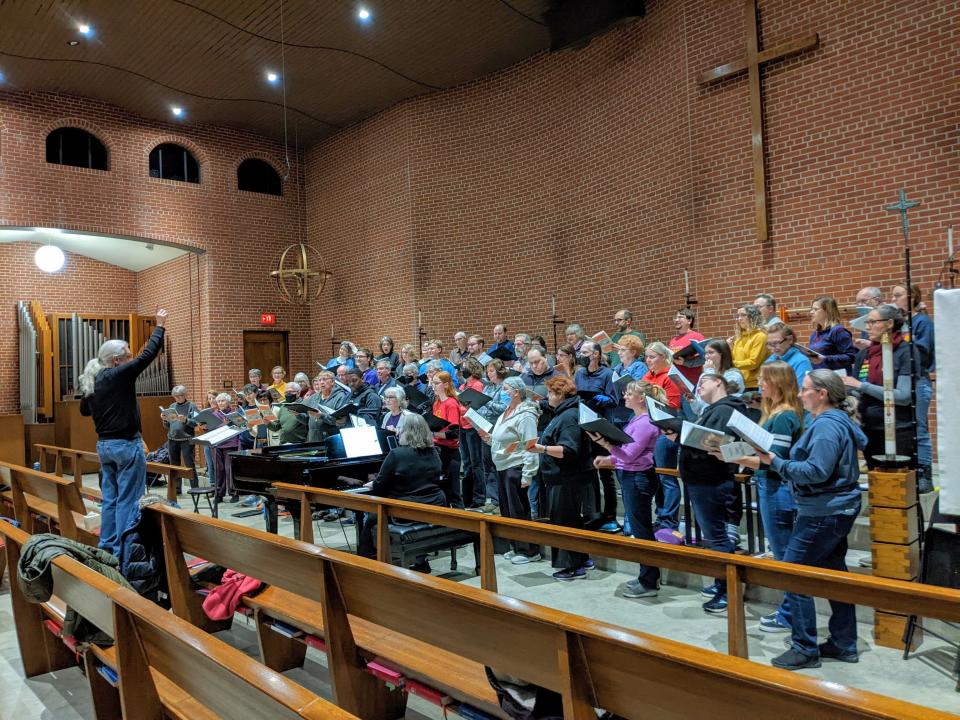 Good Company director, Steven Hoifeldt, conducts Good Company and Ames Choral Society members in preparation for their upcoming concert.