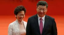 FILE PHOTO: Hong Kong Chief Executive Carrie Lam and Chinese President Xi Jinping walk after Lam took her oath in Hong Kong