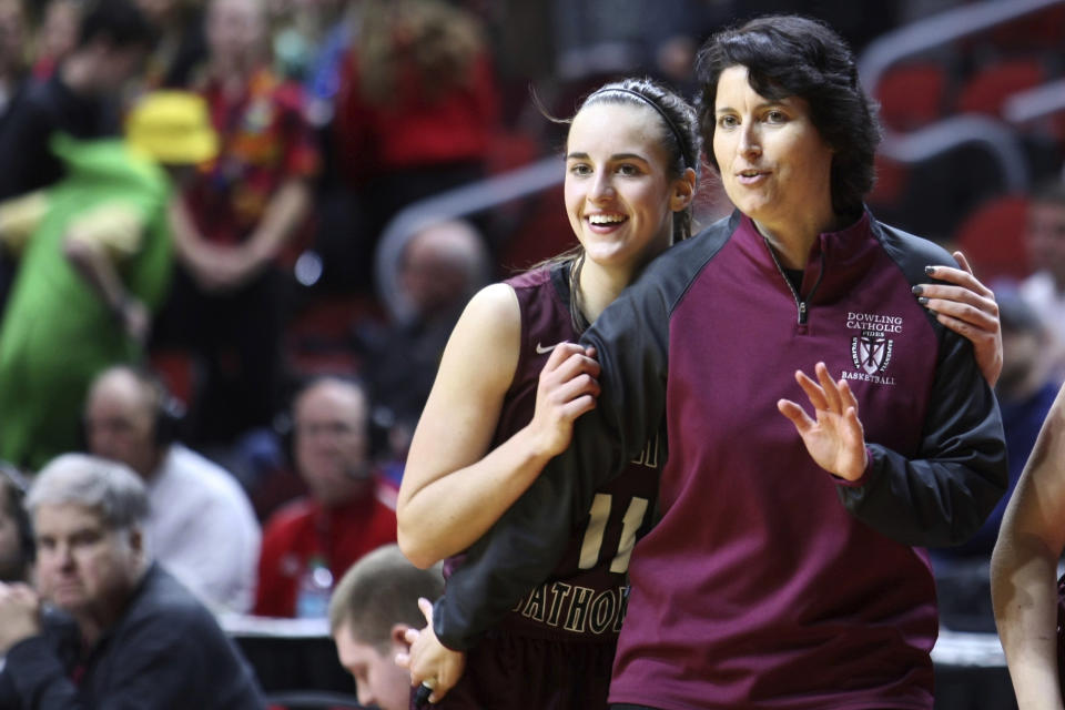 This photo provided by Dowling Catholic High School shows basketball player Caitlin Clark with head coach Kristin Meyer at the girls state tournament at Wells Fargo Arena in Des Moines, Iowa, Feb. 25, 2020. Clark is now on the cusp of becoming Division I women's basketball's all-time leading scorer. An early sign of how her career would evolve happened when she was a high school junior. In a game against Mason City she scored 60 points and made 13 3-pointers on 17 attempts. (Earl Hulst/Dowling High School via AP)