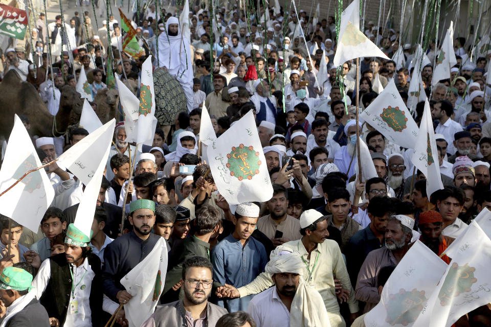 Pakistanis take part in a rally for the Mawlid al-Nabi holiday that celebrates the birthday of Islam's Prophet, Muhammad, born in the year 570, in Peshawar, Pakistan, Friday, Oct. 30, 2020. Thousands of Pakistani Muslims took part in religious processions, ceremonies and distributing free meals among the poor to mark the holiday. (AP Photo/Muhammad Sajjad)