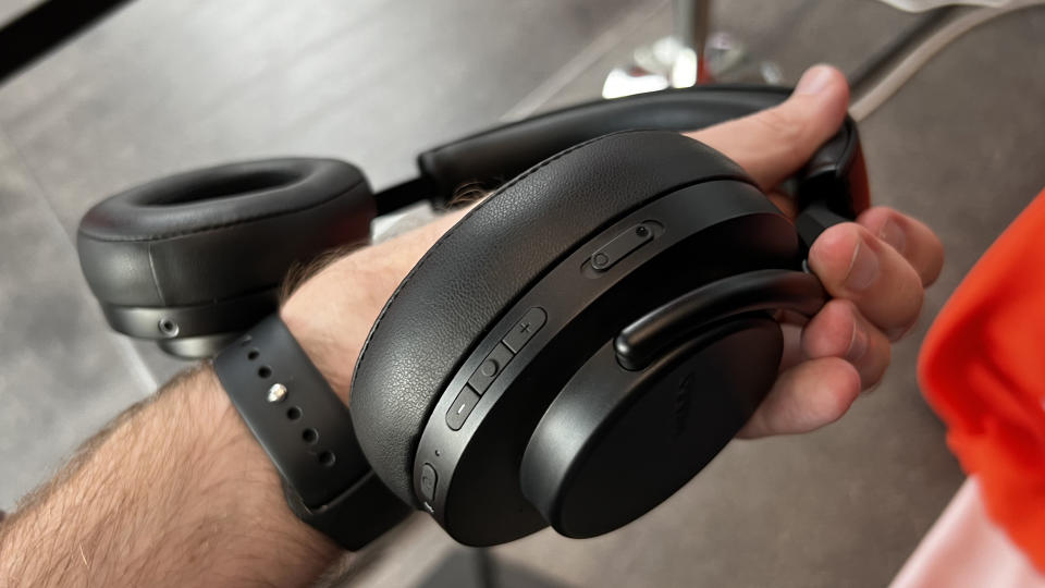 Shure AONIC 50 Gen 2 headphones held in a man's hand