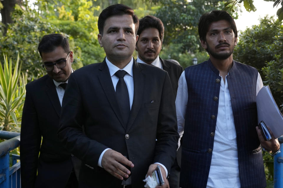 Naeem Haider Panjutha, center, a lawyer of Pakistan's former Prime Minister Imran Khan, arrives with others for a press conference after meeting with Khan in Islamabad, Pakistan, Monday, Aug. 7, 2023. Khan is now an inmate at a high-security prison after being convicted of corruption and sentenced to three years. (AP Photo/Anjum Naveed)