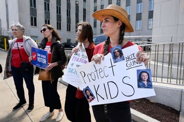 PHOTO: Lauren Giesler holds a sign with photos of her daughters as she joins other activist mothers at a rally at the state Capitol, March 28, 2023, in Nashville, Tenn., the day after a shooting at a Christian elementary school. (John Amis/AP)