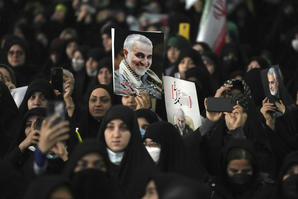 Mourners attend a ceremony marking anniversary of the death of the late Revolutionary Guard Gen. Qassem Soleimani, shown in the posters, who was killed in Iraq in a U.S. drone attack in 2020, at Imam Khomeini Grand Mosque in Tehran, Iran, Tuesday, Jan. 3, 2023. Iran's President Ebrahim Raisi on Tuesday vowed to avenge the killing of the country's top general on the third anniversary of his death, as the government rallied its supporters in mourning amid months of anti-government protests. (AP Photo/Vahid Salemi)