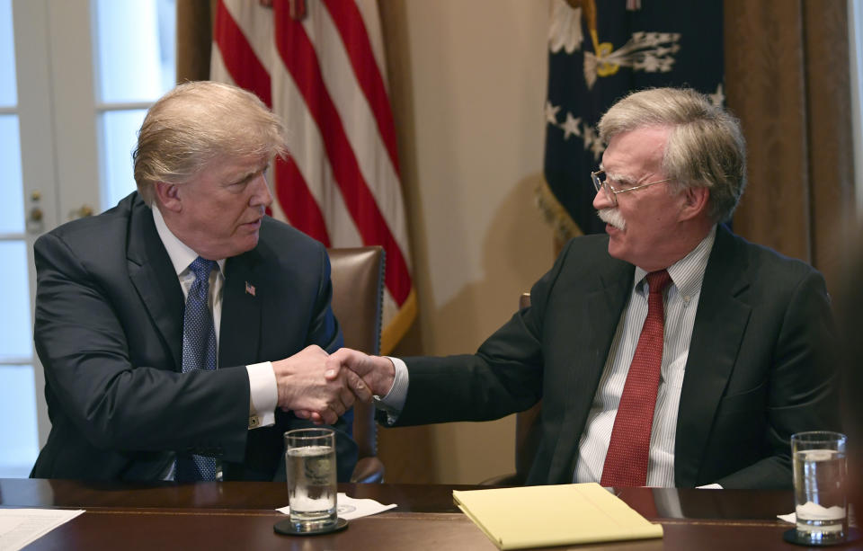 FILE - In this April 9, 2018 file photo, President Donald Trump, left, shakes hands with national security adviser John Bolton in the Cabinet Room of the White House in Washington at the start of a meeting with military leaders. Trump has fired national security adviser John Bolton. Trump tweeted Tuesday that he told Bolton Monday night that his services were no longer needed at the White House. (AP Photo/Susan Walsh)