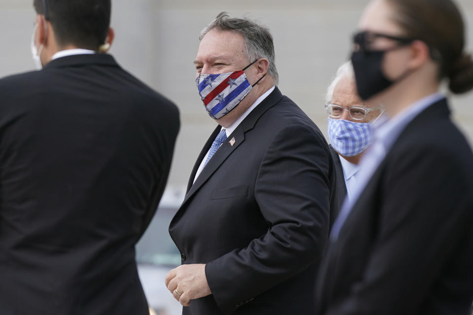 U.S. Secretary of State Mike Pompeo prepares to board a plane at Ben Gurion Airport in Tel Aviv, Friday, Nov. 20, 2020. Standing behind Pompeo is U.S. Ambassador to Israel David Friedman. Pompeo is en route to the United Arab Emirates. (AP Photo/Patrick Semansky, Pool)