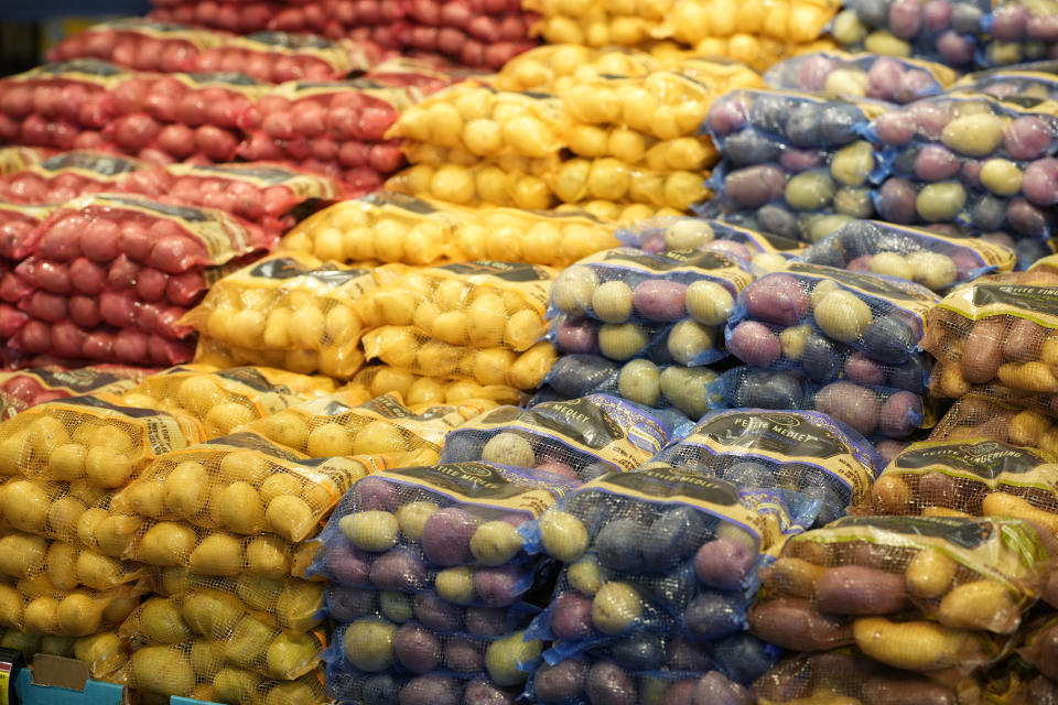 File - Bags of potatoes are displayed in a supermarket Tuesday, Feb. 8, 2022, in Boulder, Colo. Americans are bracing for a costly Thanksgiving this year, with double-digit percent increases in the price of turkey, potatoes, stuffing, canned pumpkin and other staples. (AP Photo/David Zalubowski, File)