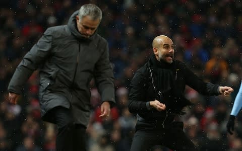 Manager Jose Mourinho of Manchester United and Manager Pep Guardiola of Manchester City watch from the touchline during the Premier League match between Manchester United and Manchester City at Old Trafford - Credit: Getty Images