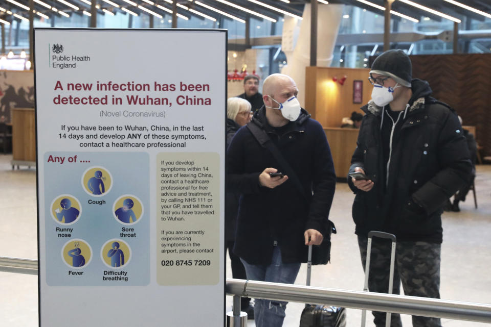 Passengers arrive at Heathrow Airport in London after the last British Airways flight from China touched down in the UK following an announcement that the airline was suspending all flights to and from mainland China with immediate effect amid the escalating coronavirus crisis, Wednesday Jan. 29, 2020. Many governments have warned against unnecessary travel to China, as efforts to contain a new and deadly coronavirus virus intensify. (Steve Parsons/PA via AP)