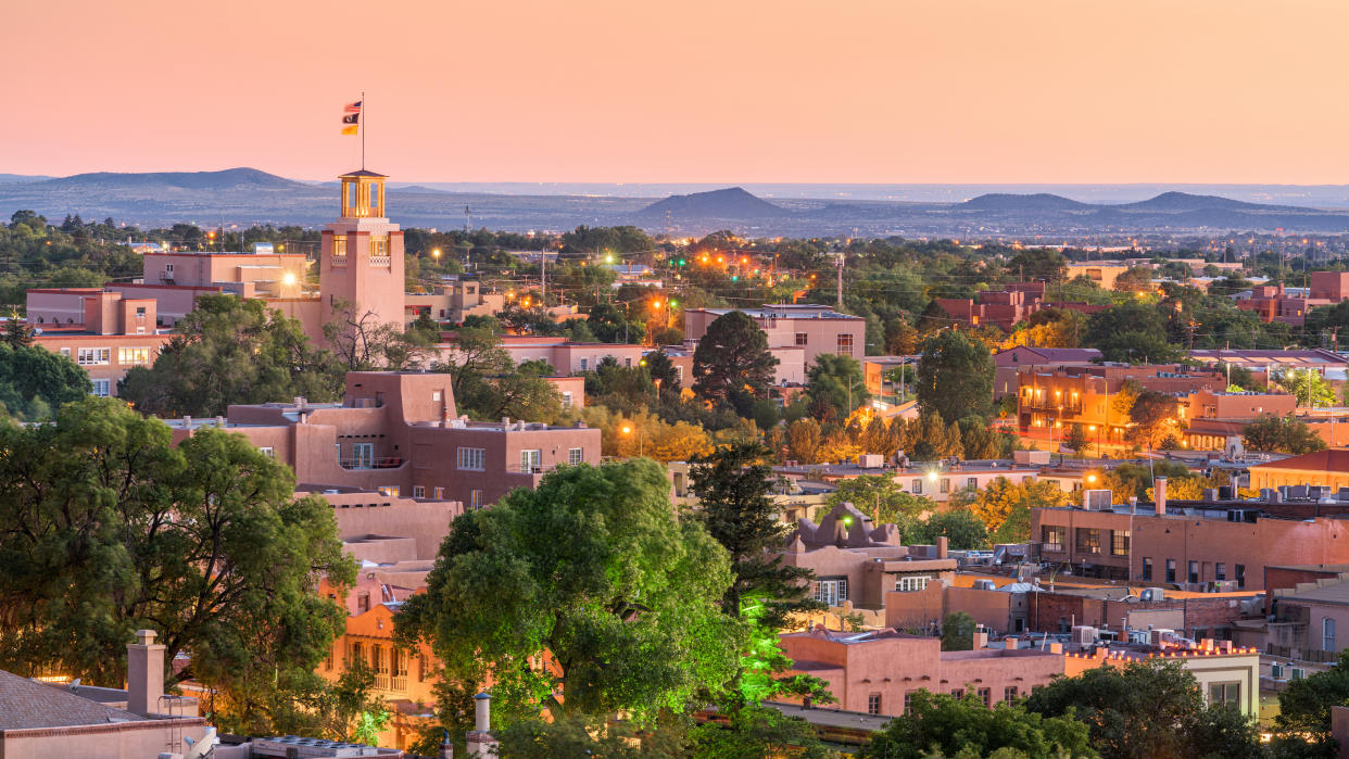  An aerial view showing downtown Santa Fe, New Mexico, at dusk. 