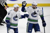 Vancouver Canucks' Nate Schmindt (88) celebrates his goal against the Winnipeg Jets with Brandon Sutter (20) during first period NHL hockey action in Winnipeg, Manitoba on Tuesday March 1, 2021. (Fred Greenslade/The Canadian Press via AP)