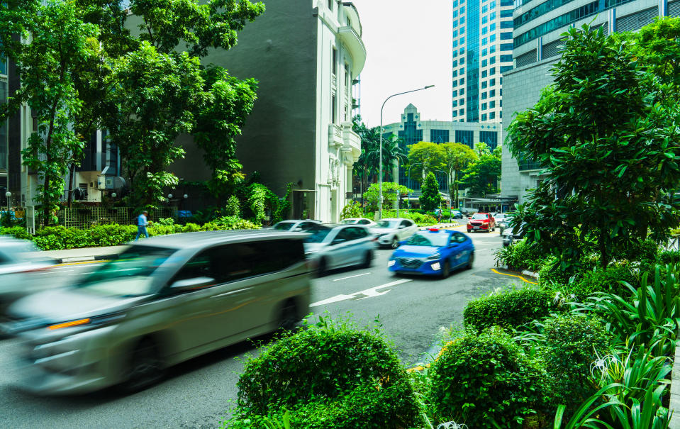 Singapore city road with traffic, cars, illustrating a piece on Cat A COEs.