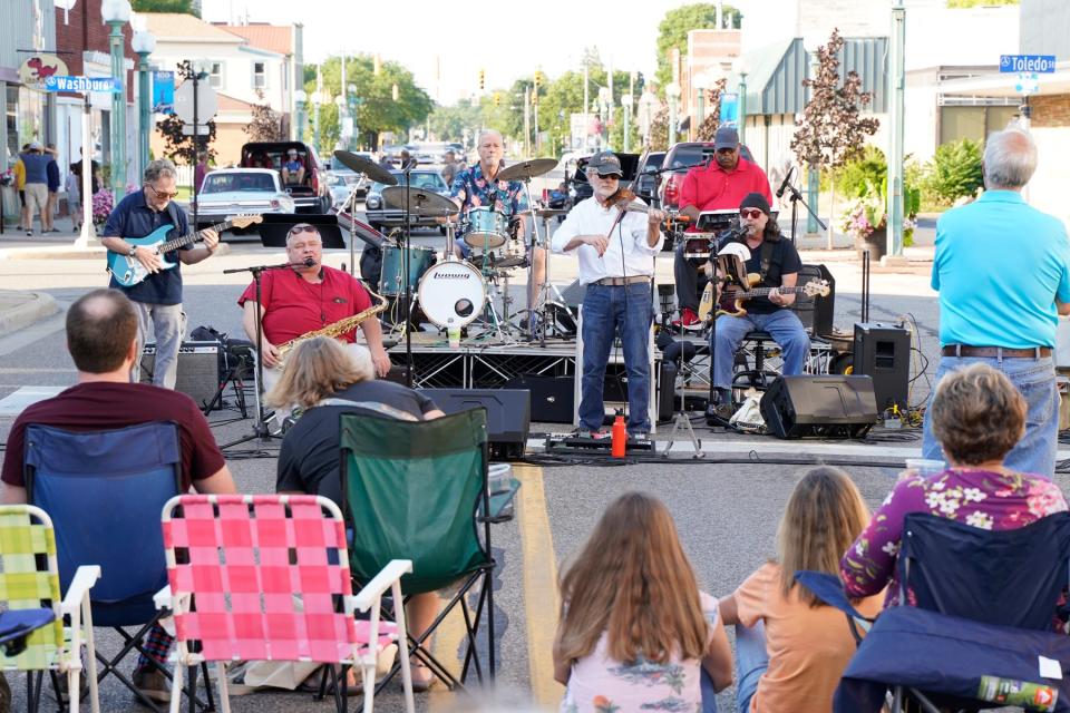 Bille Lewis and the Soulbacks are seen performing in front of a crowd during the July 2021 edition of downtown Adrian's First Fridays.