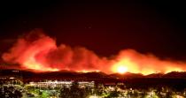 <p>In this long exposure photo, fire burns behind Cache Creek Casino Resort near Guinda, Calif. near on July 1, 2018. (Photo: Josh Edelson/AFP/Getty Images) </p>