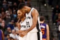 San Antonio Spurs point guard Tony Parker (left) and power forward Tim Duncan (21) talk as they head to the bench against the Phoenix Suns during the second half at AT&T Center. Mandatory Credit: Soobum Im-USA TODAY Sports