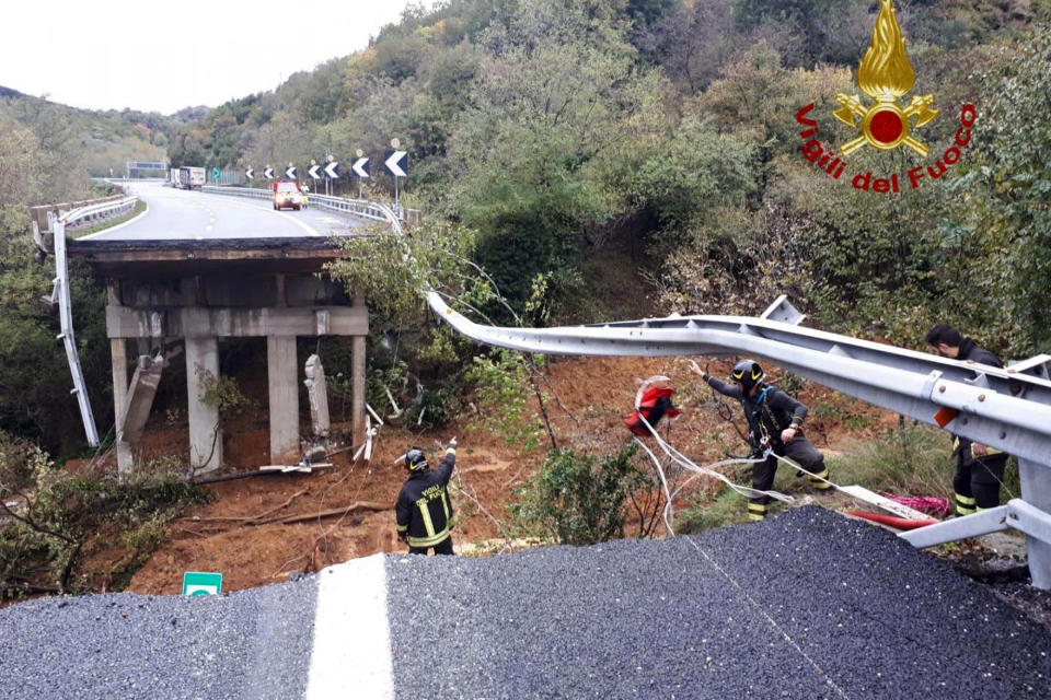 Firefighters work in the area where a stretch of the Turin to Savona A6 highway collapsed following heavy rains. Rain-swollen rivers and flooded streets plagued Italy, where it has been raining, sometimes heavily, in much of the country nearly every day for about two weeks. About a 30-meter (100-foot stretch) of highway, including an overpass, near Savona, collapsed authorities, said. Rescuers could be seen searching the area, which is part of a highway linking the coastal city with Turin, for any casualties. But there were no immediate reports of injuries. (Vigili del Fuoco via AP)