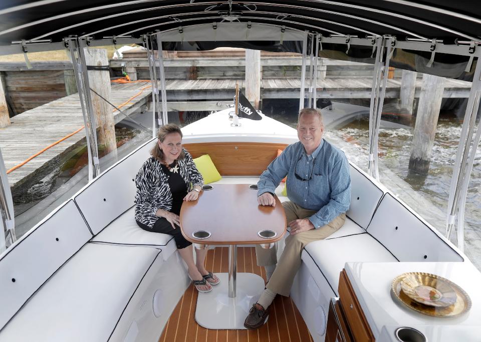 Elektra Cruise owners Susan and Bob Everhard pose on their Duffy 22 electric boat June 21, 2021, at Fox River Brewing Co. in Oshkosh. Elektra Cruise has relocated this summer to Fox Harbor Marina, 1000 Bauman St.