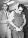 <p>James Earl Ray is led to his cell by Shelby County Sheriff William Morris. (Photo: Bettmann/Getty Images) </p>