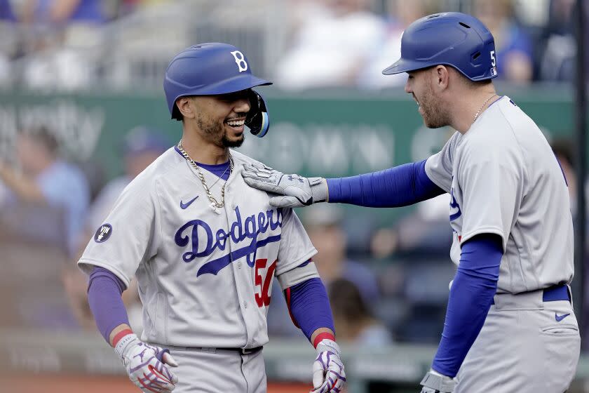 Mookie Betts, left, celebrates with Freddie Freeman after hitting a solo home run