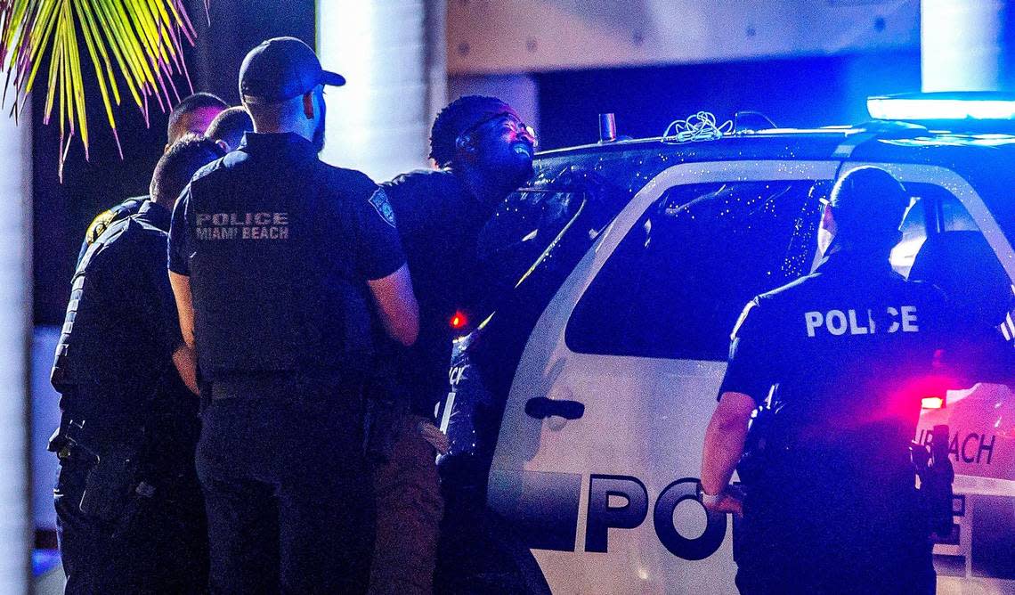 Miami Beach Police officers detained a man after midnight curfew began on Ocean Drive, during spring break in Miami Beach, on Sunday March 17, 2024.