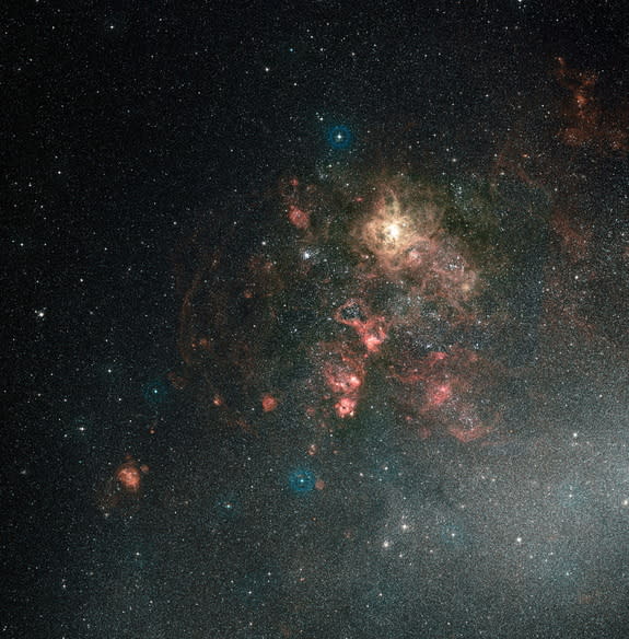 This ground-based view of the Tarantula Nebula shows the nebula in its entirety. It is the brightest region of star formation in the local Universe. Hubble’s field of view covers just a tiny spot in the upper-right quadrant of this image, thoug