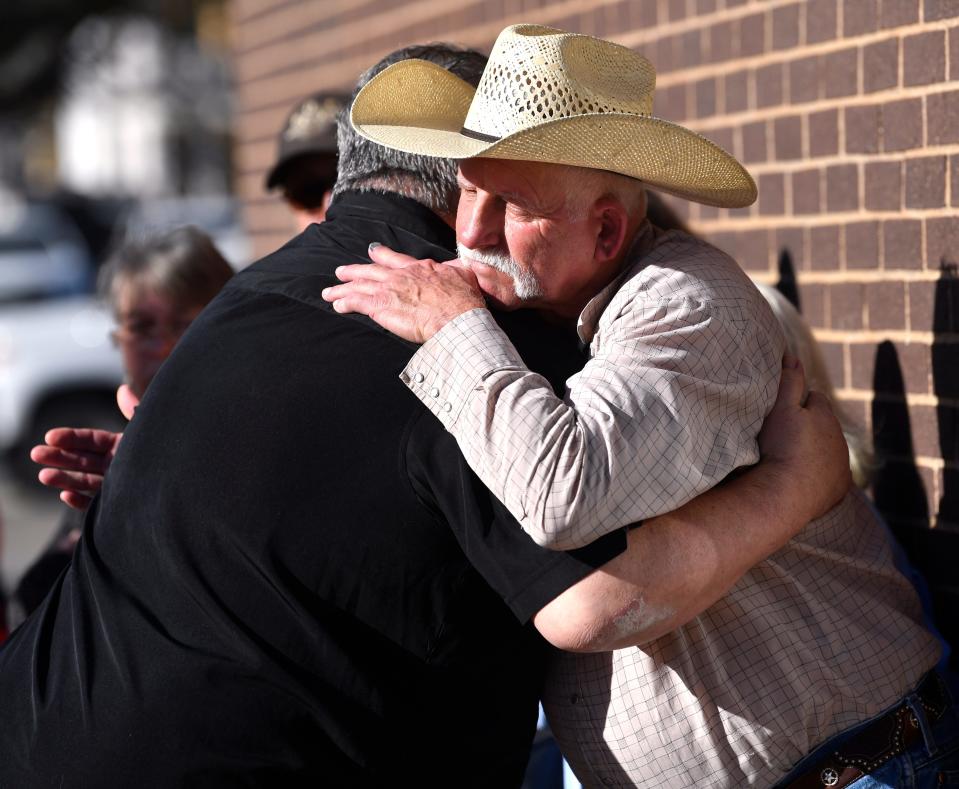 Steve Harris embraces Randall Ray, the father of Trenton Ray outside Brownwood City Hall Feb. 22.