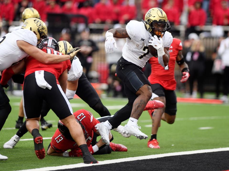 UCF's running back RJ Harvey (7) scores a touchdown against Texas Tech, Saturday, Nov. 18, 2023, at Jones AT&T Stadium.