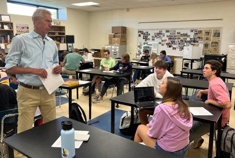 Paul Dinkenor supports “World Religions and the Bible in History” students Lila Killian (foreground), Brayden Hakerem (back left), and Brooks Booth (back right) in collaborative group work integrating talking and technology.
