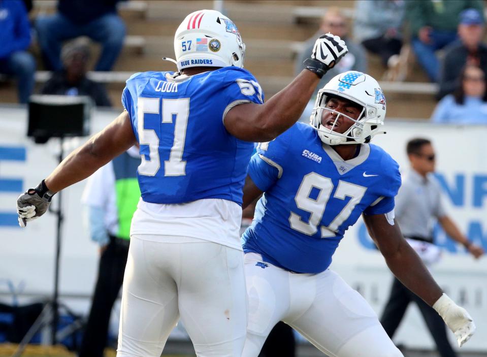 Middle Tennessee defensive end Quindarius Dunnigan (97) celebrates his sack of FIU quarterback <a class="link " href="https://sports.yahoo.com/ncaaf/players/404917" data-i13n="sec:content-canvas;subsec:anchor_text;elm:context_link" data-ylk="slk:Keyone Jenkins;sec:content-canvas;subsec:anchor_text;elm:context_link;itc:0">Keyone Jenkins</a> (1) with Middle Tennessee defensive tackle Marley Cook (57) during the MTSU’s Salute to Veterans football game in the Johnny “Red” Floyd Stadium in Murfreesboro, Tenn. on Saturday, Nov 11, 2023.