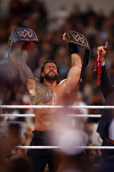 INGLEWOOD, CALIFORNIA - APRIL 02: (L-R) Roman Reigns after defeating Cody Rhodes for Undisputed WWE Universal Title Match during WrestleMania Goes Hollywood at SoFi Stadium on April 02, 2023 in Inglewood, California. (Photo by Ronald Martinez/Getty Images)