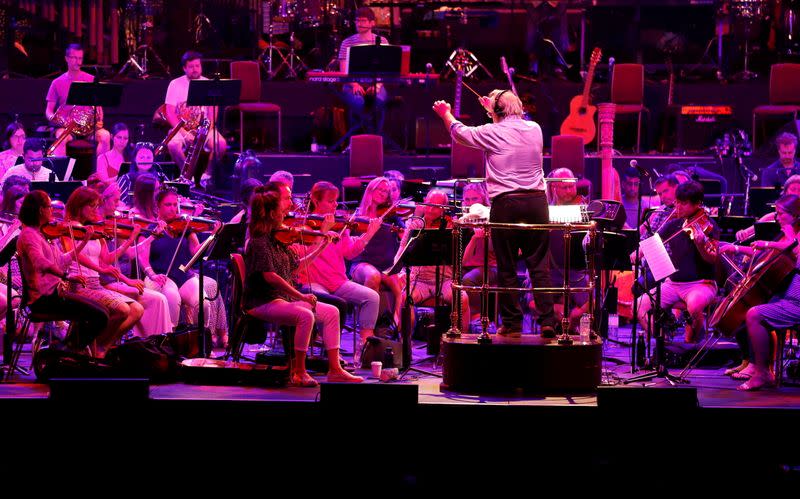 Nicholas Dodd conducts the Albert's Orchestra during a dress rehearsal of the 150th Anniversary Concert: David Arnold's 'A circle of sound', at the Royal Albert Hall
