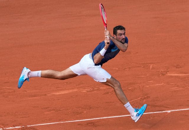 Marin Cilic plays a backhand at full stretch during his loss to Roger Federer