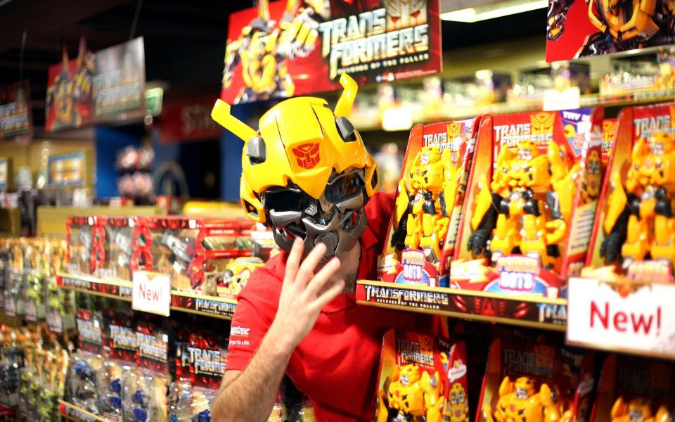 Toys are not just for young children: a member of Hamleys staff wears the Transformers Bumblebee Helmet, pictured in 2009