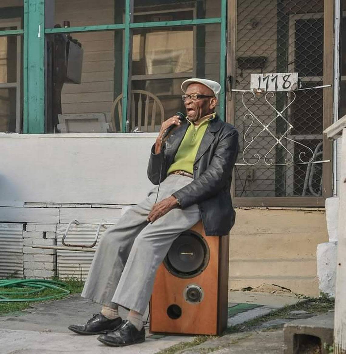 Buddy Barron sings while sitting on a speaker as part of the Macon Music Project, a photography documentary started by his grandson Dsto Moore. Courtesy Dsto Moore