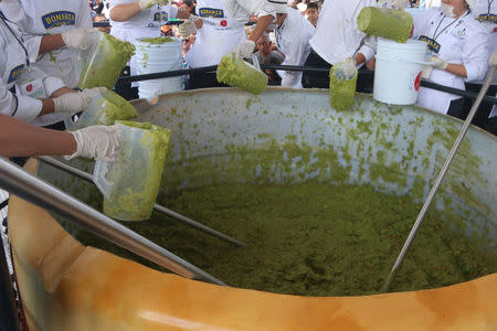 Volunteers from a culinary school mix mashed avocados as they attempt to set a new Guinness World Record for the largest serving of guacamole in Concepcion de Buenos Aires, Jalisco, Mexico September 3, 2017. REUTERS/Fernando Carranza