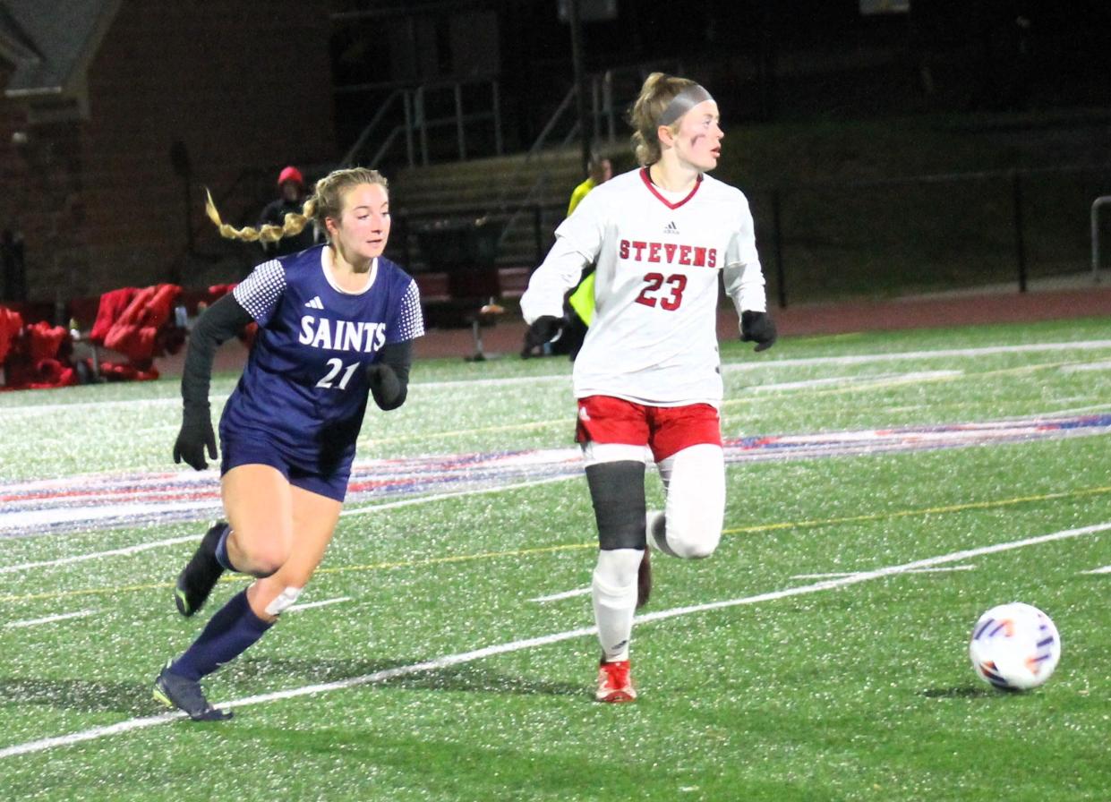 STA's Katherine Dornan, left, has her eyes on the ball as Stevens' Kylie is looking elsewhere during playoff action Wednesday night in Manchester.