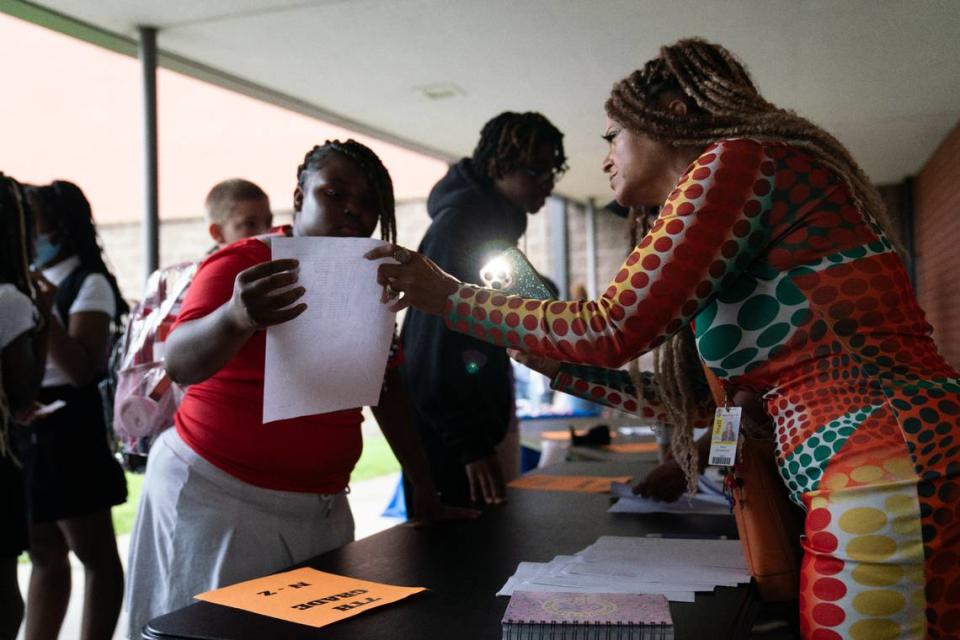 Robin Witherspoon helps a student find their respective classroom during Lincoln Middle School’s first day of school on Aug. 14, 2023. Lincoln Middle School and Officer Elementary opened on the same day, each filled with staff and community partners cheering on students as they entered the building.