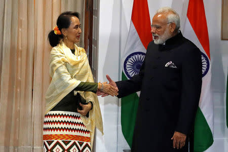 Myanmar's State Counsellor Aung San Suu Kyi shakes hands with India's Prime Minister Narendra Modi during a photo opportunity ahead of their meeting at Hyderabad House in New Delhi, India, January 24, 2018. REUTERS/Cathal McNaughton