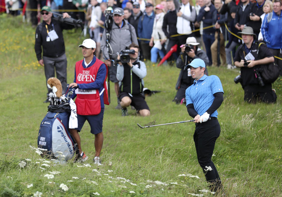 Northern Ireland's Rory McIlroy looks up after playing out of the long rough on the 1st hole during the first round of the British Open Golf Championships at Royal Portrush in Northern Ireland, Thursday, July 18, 2019.(AP Photo/Peter Morrison)