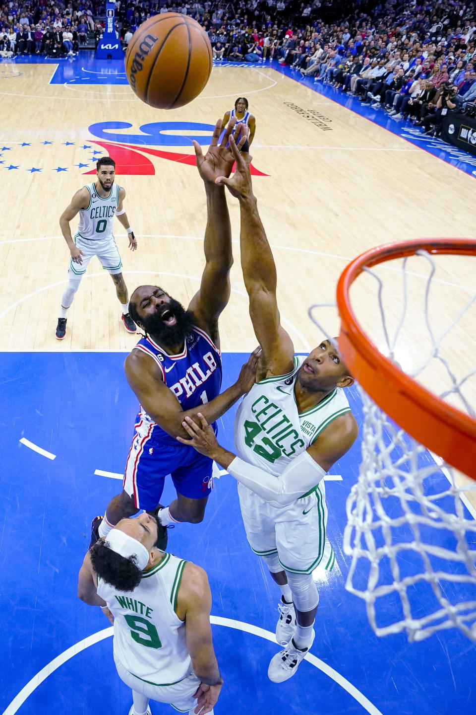 Philadelphia 76ers' James Harden, center, goes up for a shot with Boston Celtics' Al Horford, right, defending during the first half of an NBA basketball game Tuesday, April 4, 2023, in Philadelphia. (AP Photo/Chris Szagola)